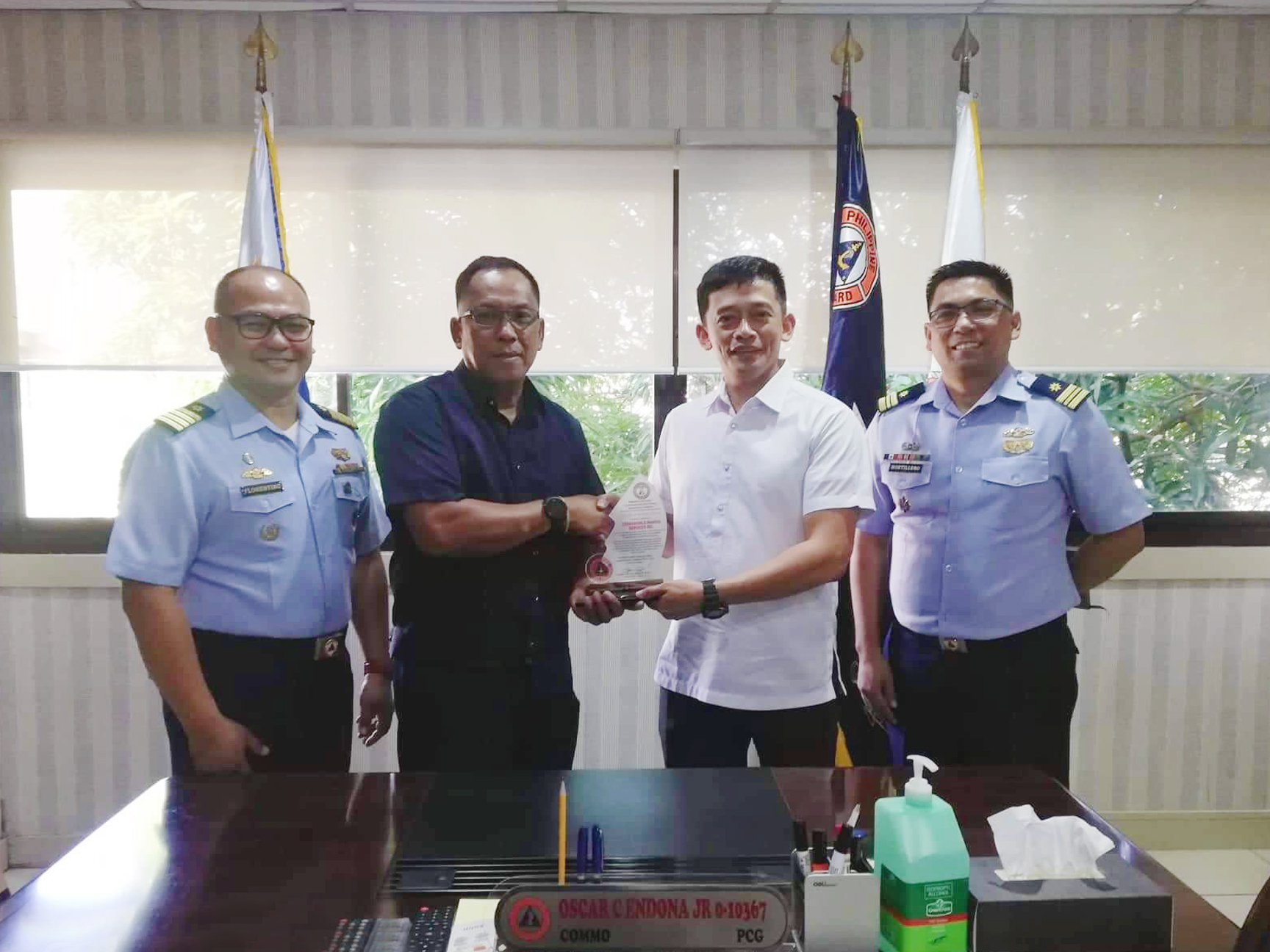 PCG Commo Endona Jr. awards plaque of appreciation to Crossworld Representative Capt Espinar